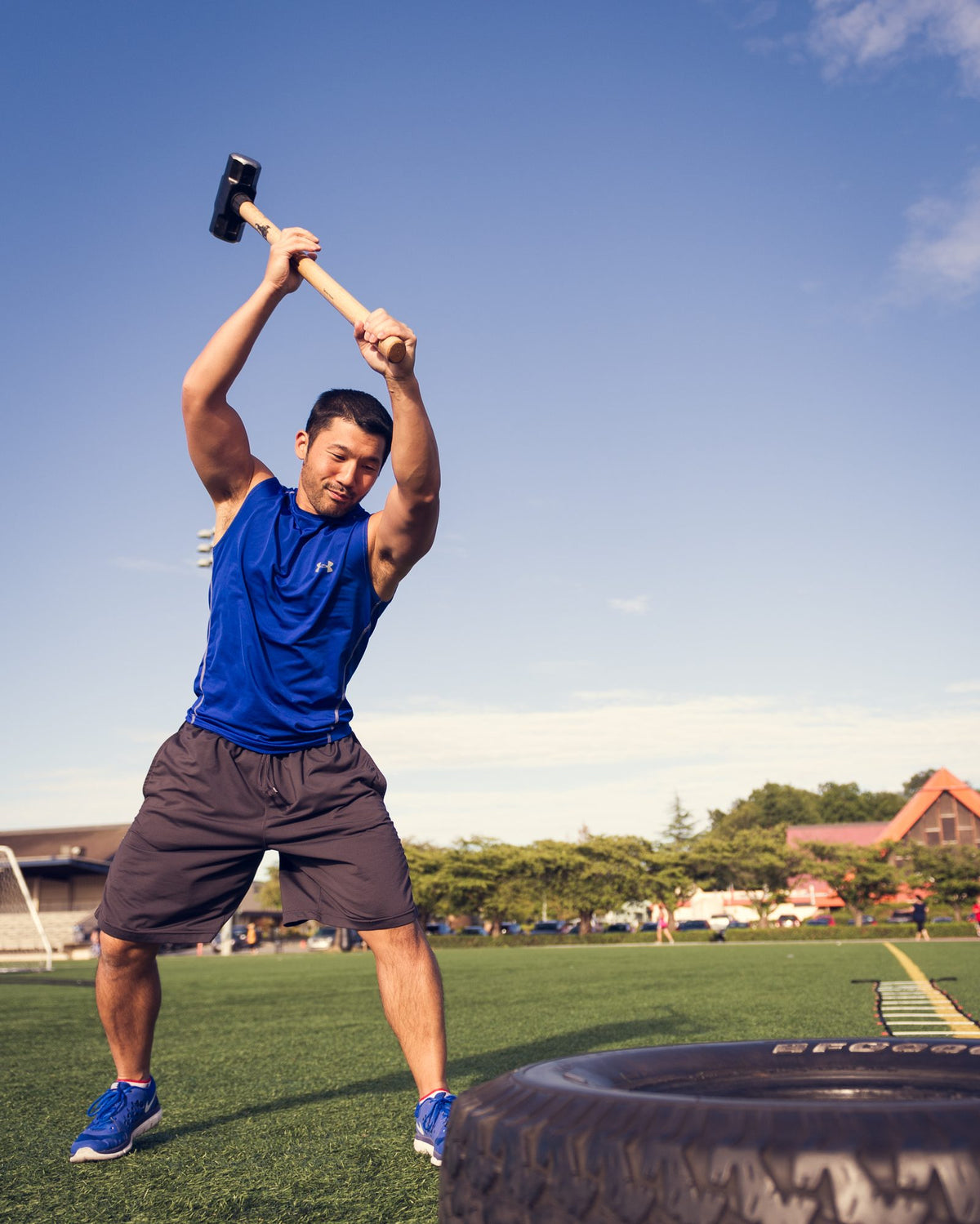 Kevin Hirose, kinesiologist in Edmonton, training an overhead movement outdoors