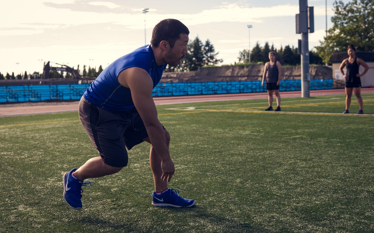 Kevin Hirose coaching a strength training session outdoors in Edmonton